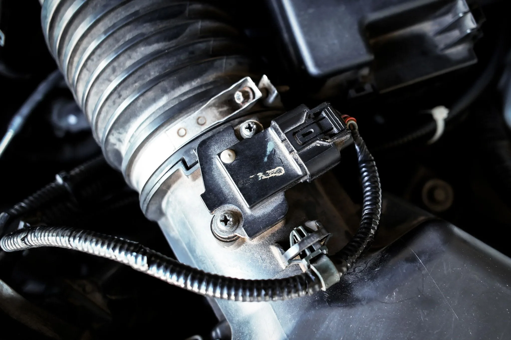 Close up of automotive mass airflow sensor on air intake manifold